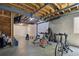 Finished basement with home gym including work out bike, weight set, bench, and exposed wooden ceiling at 8721 E 23Rd Ave, Denver, CO 80238
