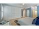 Spacious bedroom with large closet, natural light, ensuite bathroom access, light walls, and hardwood floors at 8721 E 23Rd Ave, Denver, CO 80238