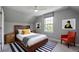 Bedroom with a wooden bed frame, gray walls, and a blue striped rug at 8721 E 23Rd Ave, Denver, CO 80238