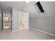 Light-filled bedroom features neutral tones, a skylight, and an adjacent bathroom at 8721 E 23Rd Ave, Denver, CO 80238