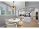 Bright breakfast nook open to kitchen with large windows and seating for four at 8721 E 23Rd Ave, Denver, CO 80238