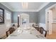 Formal dining room with light-colored wood floors, wainscotting, modern chandelier, and seating for six at 8721 E 23Rd Ave, Denver, CO 80238