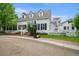 Two-story home with white exterior, black shutters, dormer windows, and a basketball hoop in the driveway at 8721 E 23Rd Ave, Denver, CO 80238