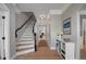 Elegant foyer with hardwood floors, a staircase, and stylish decor creating a warm and inviting entrance at 8721 E 23Rd Ave, Denver, CO 80238