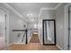 Hallway features hardwood floors, decorative lighting, and a large mirror at 8721 E 23Rd Ave, Denver, CO 80238