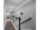 Upstairs hallway with decorative lighting, hardwood floors and stairway at 8721 E 23Rd Ave, Denver, CO 80238