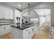 Open concept kitchen with stainless steel appliances, island cooktop, breakfast nook, and connected living area at 8721 E 23Rd Ave, Denver, CO 80238