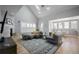 Bright living room with vaulted ceiling, skylight, fireplace, and plush seating area at 8721 E 23Rd Ave, Denver, CO 80238