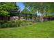 Fenced in community pool, surrounded by grass and trees at 8721 E 23Rd Ave, Denver, CO 80238