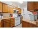 Well-lit kitchen with wooden cabinets and white appliances, creating a clean and efficient space at 11923 E Ford Dr, Aurora, CO 80012