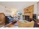 Cozy living room showcases a stone fireplace, wood floors, and access to the outdoors at 11923 E Ford Dr, Aurora, CO 80012
