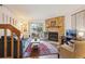 Inviting living room featuring a stone fireplace, sliding doors, and comfortable seating at 11923 E Ford Dr, Aurora, CO 80012