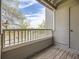 Private balcony showcasing wood floors and railing with lovely neighborhood views and a tranquil outdoor space at 5745 W Atlantic Pl # 207, Lakewood, CO 80227