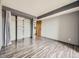 Bright empty bedroom with wood laminate floors, closet, and laundry at 5745 W Atlantic Pl # 207, Lakewood, CO 80227
