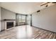 Bright living room featuring a fireplace, hardwood floors, and sliding glass doors at 5745 W Atlantic Pl # 207, Lakewood, CO 80227