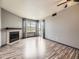 Bright living room featuring a fireplace, hardwood floors, and sliding glass doors at 5745 W Atlantic Pl # 207, Lakewood, CO 80227