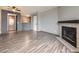 Open living area with wood floors, fireplace, and entrance to the kitchen at 5745 W Atlantic Pl # 207, Lakewood, CO 80227