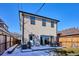 View of the back exterior with a backyard patio featuring an outdoor dining set and modern architectural details at 2122 S Ogden St, Denver, CO 80210