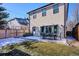 Backyard view of the home, showcasing the outdoor dining set and patio area in a well maintained yard at 2122 S Ogden St, Denver, CO 80210