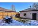 Backyard features a patio with a modern outdoor dining set and a grassy area, perfect for entertaining at 2122 S Ogden St, Denver, CO 80210