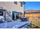 Backyard view features outdoor dining on concrete patio, sliding glass doors and wood fence at 2122 S Ogden St, Denver, CO 80210