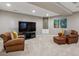 Basement Gathering room area with two leather armchairs and a TV, creating a cozy entertainment space at 2122 S Ogden St, Denver, CO 80210