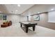 Finished basement space featuring a pool table and a leather lounging chair with neutral carpeting at 2122 S Ogden St, Denver, CO 80210