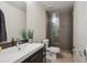 Modern bathroom showcasing a sleek vanity with a white vessel sink and a glass shower with contemporary tiling at 2122 S Ogden St, Denver, CO 80210