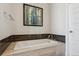 Clean bathtub with tile surround and chrome hardware at 2122 S Ogden St, Denver, CO 80210