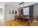 Dining room featuring hardwood floors, large window, and view of the modern light fixture at 2122 S Ogden St, Denver, CO 80210