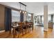 Open dining room with hardwood floors, a modern light fixture, and living room access at 2122 S Ogden St, Denver, CO 80210