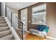 Bright entryway with hardwood floors, a modern staircase, and a comfortable bench seat at 2122 S Ogden St, Denver, CO 80210