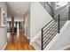 Spacious hallway featuring hardwood floors, a modern staircase, and neutral paint at 2122 S Ogden St, Denver, CO 80210