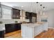 Bright kitchen featuring an island with granite countertops and a stainless steel vent hood at 2122 S Ogden St, Denver, CO 80210