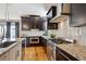 Modern kitchen featuring stainless steel appliances, granite countertops and wooden floors at 2122 S Ogden St, Denver, CO 80210