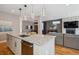 Open-concept kitchen with an island and stainless steel dishwasher and view of the fireplace at 2122 S Ogden St, Denver, CO 80210