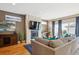 Bright living room with a fireplace, television, comfortable couch and blue accent pillows at 2122 S Ogden St, Denver, CO 80210