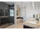 Main bathroom featuring a glass enclosed shower, soaking tub, and double sink vanity with granite counters at 2122 S Ogden St, Denver, CO 80210