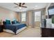 Bright main bedroom featuring a large bed, dark furniture and two windows for natural light at 2122 S Ogden St, Denver, CO 80210