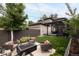 Backyard with gas fire pit surrounded by outdoor seating and lush landscaping at 1927 S Grant St, Denver, CO 80210