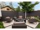 Backyard patio features comfortable seating around a gas fire pit surrounded by lush landscaping at 1927 S Grant St, Denver, CO 80210