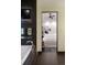 Modern bathroom featuring a soaking tub with tile surround and a glimpse into the bedroom, creating a spa-like retreat at 1927 S Grant St, Denver, CO 80210