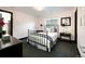 Cozy bedroom with a black iron bed frame, black furniture, pink walls and an open door at 1927 S Grant St, Denver, CO 80210
