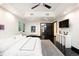 Bright, spacious bedroom with dark wood floors, white walls, recessed lights, large windows, and stylish decor at 1927 S Grant St, Denver, CO 80210
