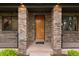 Close-up of the front entrance with a modern wood door and brick columns at 1927 S Grant St, Denver, CO 80210