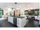 Modern, open kitchen with stainless steel appliances and a fireplace, seamlessly transitioning to the living area at 1927 S Grant St, Denver, CO 80210