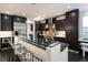 Sleek kitchen featuring dark cabinets, stainless steel appliances, and a spacious island at 1927 S Grant St, Denver, CO 80210