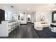Bright and airy living space with sleek black floors, minimalist furniture, and ample natural light at 1927 S Grant St, Denver, CO 80210