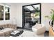 Bright living room with comfortable seating, opening to an outdoor dining area for seamless entertaining at 1927 S Grant St, Denver, CO 80210