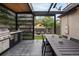 Outdoor kitchen and dining area, complete with grill and covered seating, ideal for entertaining at 1927 S Grant St, Denver, CO 80210